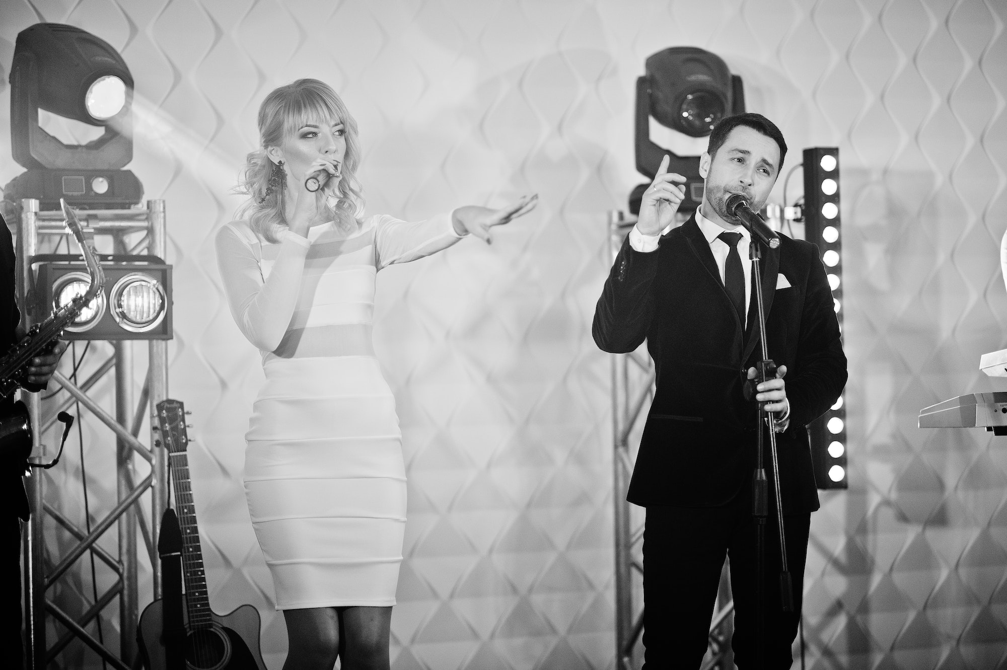 Musicial music live band performing on a stage with different lights.