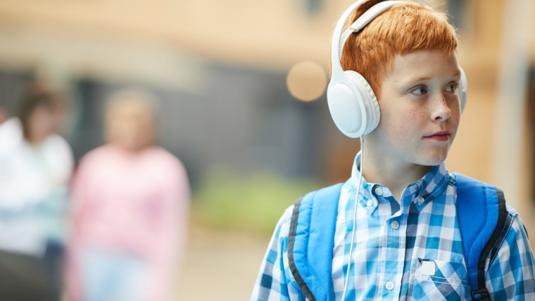 Schoolboy listening to music