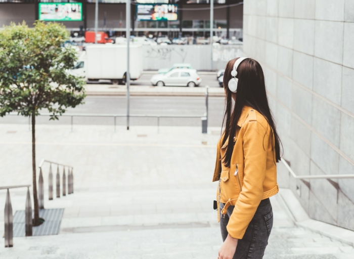 Young woman outdoor listening music